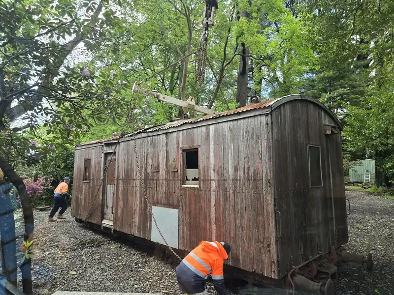 Crew rigging a small timber building for a lift on a bush block